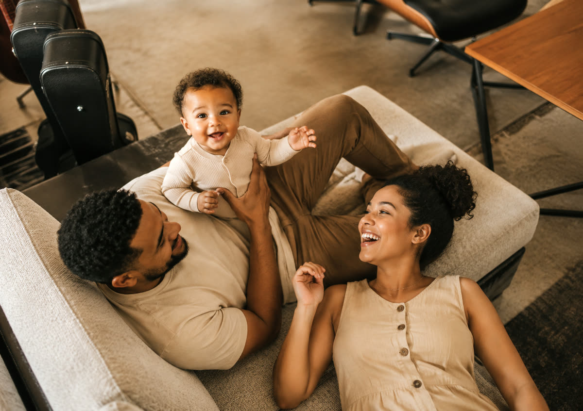 Parents laughing with their baby at home